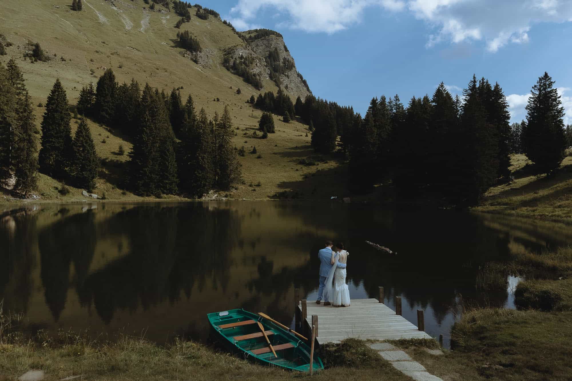Wedding couple on a deck after their sunrise elopement.
