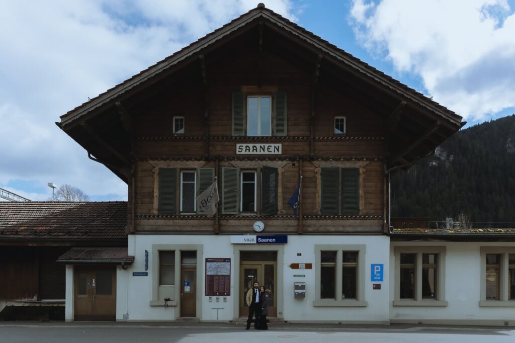 Couple seated in front of Saanen train station, one of DDLJ's famous filming location in Switzerland.