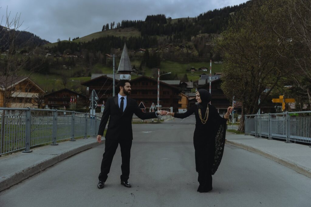 Couple dancing on the famous DDLJ bridge in Saanen, Switzerland.