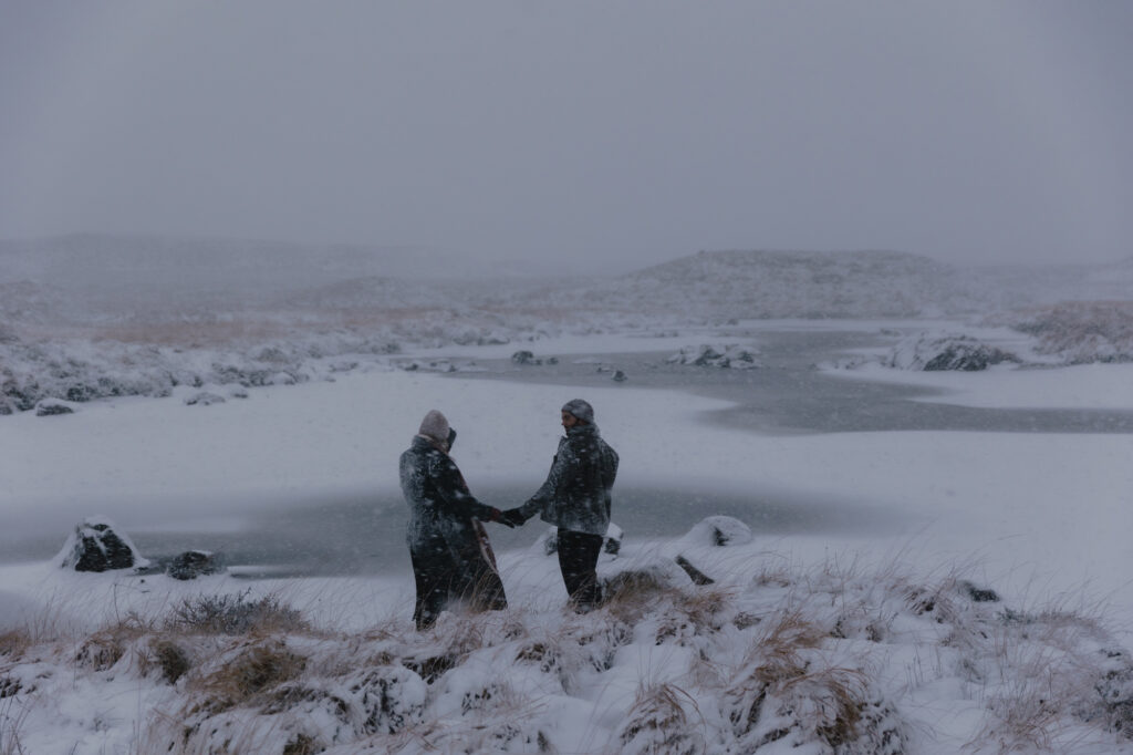 Couple holding hands during a snowstorm in Glencoe.