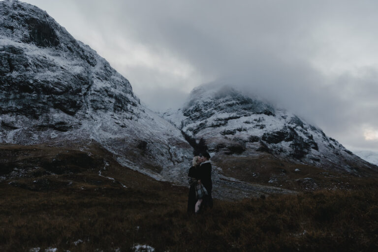 couple kissing in Glencoe, Scotland.